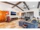 Stylish living room with exposed beams, stone floors, comfortable seating, and a cozy atmosphere at 9385 Mohawk St, Las Vegas, NV 89139