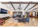 Expansive living area featuring exposed beam ceiling, stone floors, plush seating, and a game area at 9385 Mohawk St, Las Vegas, NV 89139