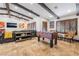 Spacious living room features exposed beam ceiling, comfortable seating, stylish decor, and foosball table at 9385 Mohawk St, Las Vegas, NV 89139