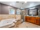 Spacious bathroom featuring a jacuzzi tub, a glass shower, and granite countertops at 9385 Mohawk St, Las Vegas, NV 89139
