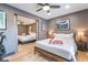 Comfortable main bedroom featuring a ceiling fan, sliding doors to another bedroom, and stylish decor at 9385 Mohawk St, Las Vegas, NV 89139