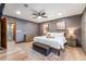 Comfortable main bedroom featuring a ceiling fan, sliding doors, and an ensuite bathroom at 9385 Mohawk St, Las Vegas, NV 89139