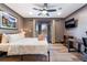 Comfortable bedroom featuring a ceiling fan, wood floors, and glass doors to the backyard at 9385 Mohawk St, Las Vegas, NV 89139