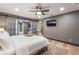 Comfortable main bedroom featuring a ceiling fan, sliding doors to another bedroom, and wood flooring at 9385 Mohawk St, Las Vegas, NV 89139