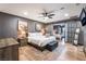 Comfortable main bedroom featuring a ceiling fan, sliding doors to another bedroom, and stylish decor at 9385 Mohawk St, Las Vegas, NV 89139