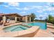 A gorgeous pool and spa offer a relaxing backyard oasis complete with a basketball hoop and ample patio space at 9385 Mohawk St, Las Vegas, NV 89139