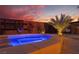 Relaxing jacuzzi-style pool with stylish deck, mood lighting, and privacy fencing offers an intimate outdoor retreat at 9385 Mohawk St, Las Vegas, NV 89139
