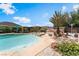 Backyard pool and spa with an outdoor fire pit, desert landscaping, and entertaining spaces at 9385 Mohawk St, Las Vegas, NV 89139