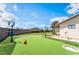 Backyard putting green for golf enthusiasts, set amongst lush landscaping and ambient lighting at 9385 Mohawk St, Las Vegas, NV 89139