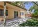 Backyard with a covered patio, lush lawn, and mature landscaping at 9814 Gifthouse St, Las Vegas, NV 89178
