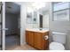 Well-lit bathroom features a wooden vanity, white countertop, and standard toilet at 9814 Gifthouse St, Las Vegas, NV 89178