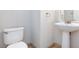Powder room with pedestal sink and modern fixtures providing a clean and functional space at 9814 Gifthouse St, Las Vegas, NV 89178
