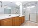 Bathroom featuring double sinks, a glass-enclosed shower, and neutral tiled flooring at 9814 Gifthouse St, Las Vegas, NV 89178