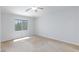 Carpeted bedroom with natural light, a ceiling fan, and a window with neighborhood views at 9814 Gifthouse St, Las Vegas, NV 89178