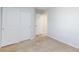 Carpeted bedroom featuring a closet with sliding doors and an open doorway at 9814 Gifthouse St, Las Vegas, NV 89178