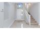 Bright foyer featuring tile flooring, staircase, and high ceilings at 9814 Gifthouse St, Las Vegas, NV 89178