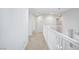 Upstairs hallway featuring white banister, light walls and carpet flooring, creating an airy ambiance at 9814 Gifthouse St, Las Vegas, NV 89178