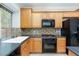 Functional kitchen has an oven, microwave, cooktop, backsplash and bright window views at 9814 Gifthouse St, Las Vegas, NV 89178