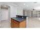 Kitchen island offers extra prep space and a casual dining area, with views into the living space at 9814 Gifthouse St, Las Vegas, NV 89178