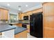 Well-equipped kitchen features ample counter space, black appliances, and wooden cabinetry at 9814 Gifthouse St, Las Vegas, NV 89178