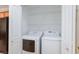 Convenient laundry room with appliances included, located near the kitchen, featuring overhead shelving at 9814 Gifthouse St, Las Vegas, NV 89178