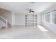 Bright, open-concept living area with tile floors and built-in shelving at 9814 Gifthouse St, Las Vegas, NV 89178