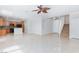 Spacious living area with tile floors, open kitchen, and staircase at 9814 Gifthouse St, Las Vegas, NV 89178