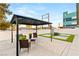Gazebo in modern courtyard with seating area, turf squares, and privacy fence at , Las Vegas, NV 89101