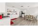Clean, all-white kitchen with a stainless steel refrigerator and dining table with chairs at , Las Vegas, NV 89101