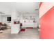 Modern, all-white kitchen with open shelving and stainless steel appliances with wood vinyl flooring at , Las Vegas, NV 89101