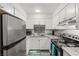 Kitchen with stainless steel appliances, gray backsplash, granite countertops, and white cabinets at , Las Vegas, NV 89101