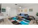 Open living room with a blue sofa, modern rug, and wood-look floors at , Las Vegas, NV 89101