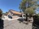 A well-kept backyard with gravel landscaping, mature trees, and a covered patio at , Las Vegas, NV 89145