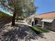 Landscaped backyard offers gravel, mature shade trees, covered patio, and dining area at , Las Vegas, NV 89145