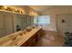 Bright bathroom featuring double sinks, a bathtub, and a separate glass-enclosed shower at , Las Vegas, NV 89145