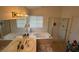 Bright bathroom featuring double sinks, a bathtub, and a separate glass-enclosed shower at , Las Vegas, NV 89145