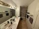 Dual sinks and ample countertop space highlight this well-lit bathroom at , Las Vegas, NV 89145