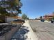 Wide street view of the community featuring desert landscaping and nearby houses at , Las Vegas, NV 89145
