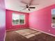 Bright pink bedroom with carpeted floor and a ceiling fan at 1012 Water Cove St, Henderson, NV 89011