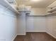 Walk-in closet with multiple shelving units and carpeted floor at 1012 Water Cove St, Henderson, NV 89011