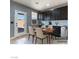 Charming dining area with seating for four, dark cabinets, and easy access to the backyard at 1012 Water Cove St, Henderson, NV 89011