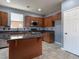 Modern kitchen featuring wood cabinets, stainless steel appliances, granite countertops, and a kitchen island at 1012 Water Cove St, Henderson, NV 89011