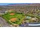 Expansive aerial view showcasing the community's baseball fields, pool, and lush green spaces at 10198 Timber Willow Ave, Las Vegas, NV 89135