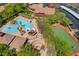 Community aerial view featuring a pool, basketball court, playground, and covered parking at 10198 Timber Willow Ave, Las Vegas, NV 89135