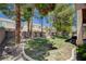 Large backyard featuring mature trees, a brick fence and ample space for outdoor activities at 10198 Timber Willow Ave, Las Vegas, NV 89135