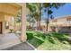 View of the patio and grassy backyard. Mature trees and rock landscaping at 10198 Timber Willow Ave, Las Vegas, NV 89135