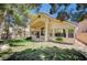 A beautiful backyard showing the home's architecture, landscaping and patio area at 10198 Timber Willow Ave, Las Vegas, NV 89135