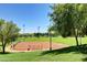 Community baseball field surrounded by grassy hills and trees at 10198 Timber Willow Ave, Las Vegas, NV 89135