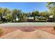 Full basketball court in an outdoor community area with lush green trees at 10198 Timber Willow Ave, Las Vegas, NV 89135