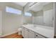 Bathroom featuring a vanity with wood cabinets, white countertop, and a large mirror at 10198 Timber Willow Ave, Las Vegas, NV 89135